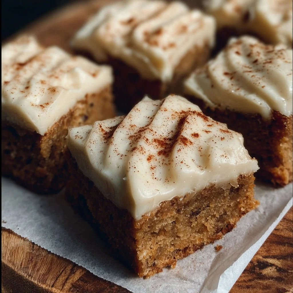 Delicious apple cinnamon blondies with maple cream cheese frosting on a plate