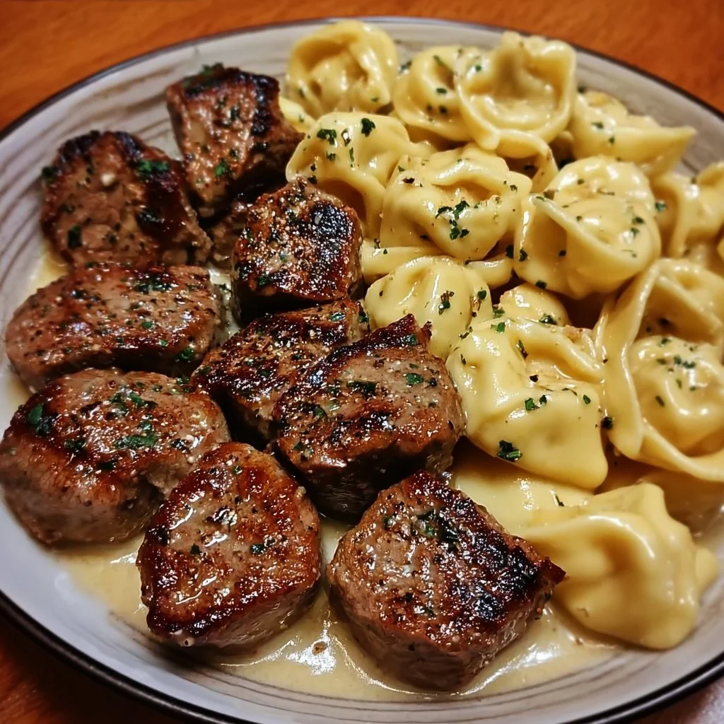 Delicious garlic butter steak bites served with creamy alfredo tortellini