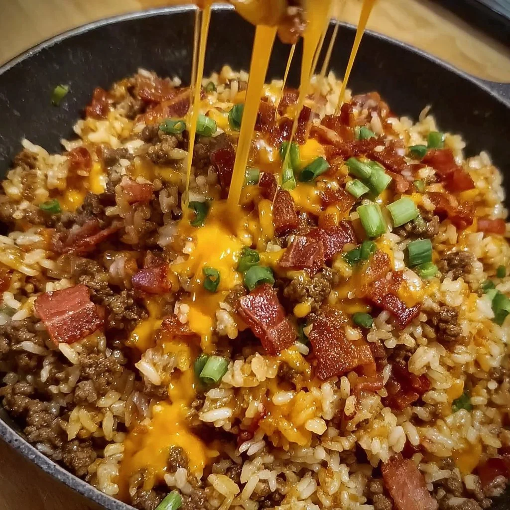 Bacon Cheeseburger Rice Skillet topped with melted cheese and crispy bacon.